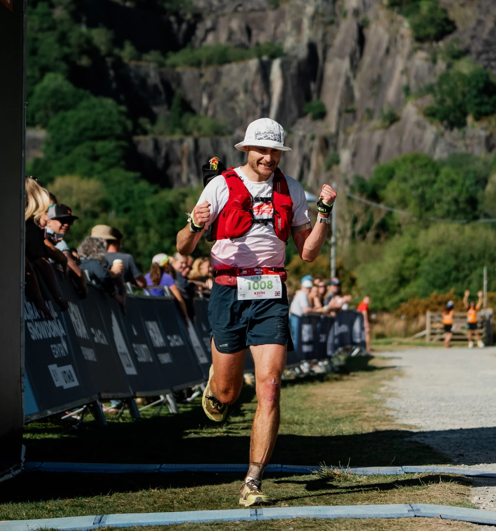 Keith smiling as he runs towards the finish line in Eryri